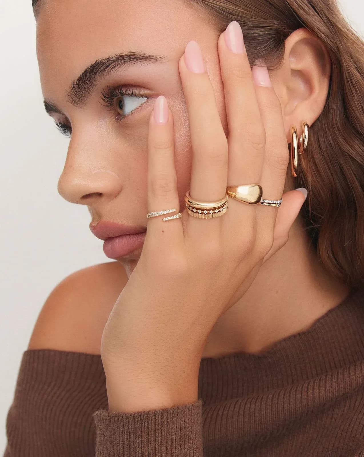 The ring worn, hand raised to the face