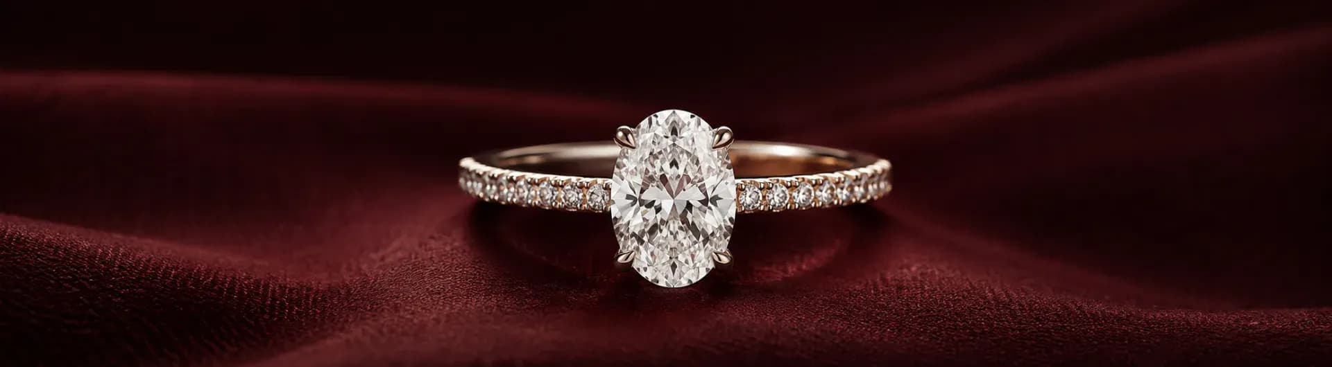 A solitaire ring resting on red silk